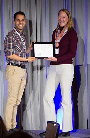 woman handing man a certificate