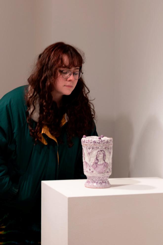 person looking at a vase